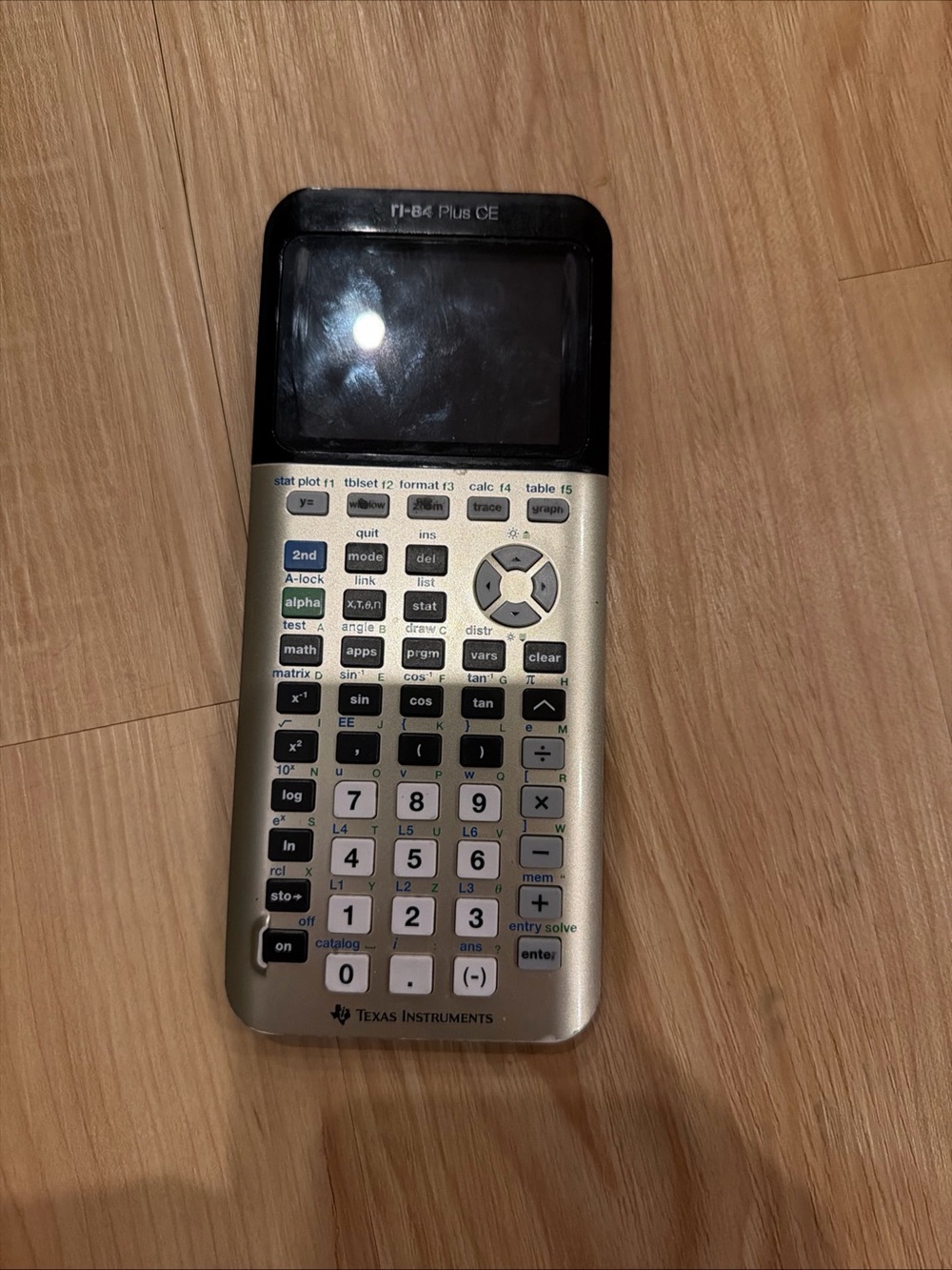 Texas Instruments Gold Graphing Calculator with Black Display